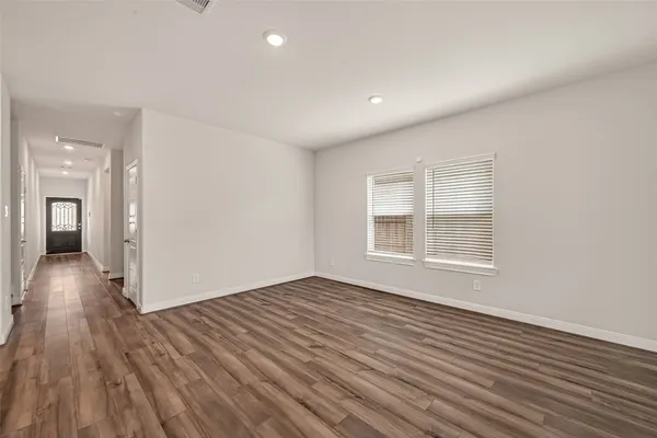wooden floor in an empty room with a window