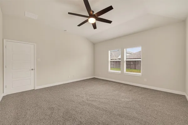 an empty room with a window and a fan