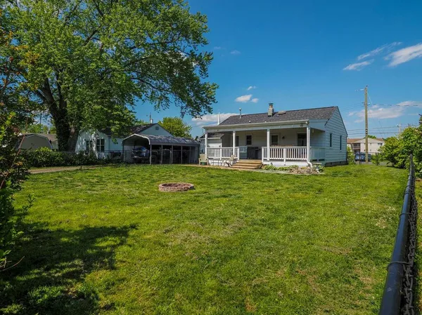 a view of a house with a yard deck and sitting area