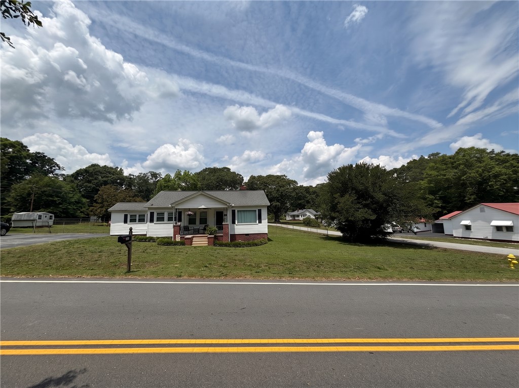 710 O Neal Street Belton, SC 29627 - Photo 2 of 18 A charming cottage residence with a neatly manicured lawn awaits, offering serene curb appeal.