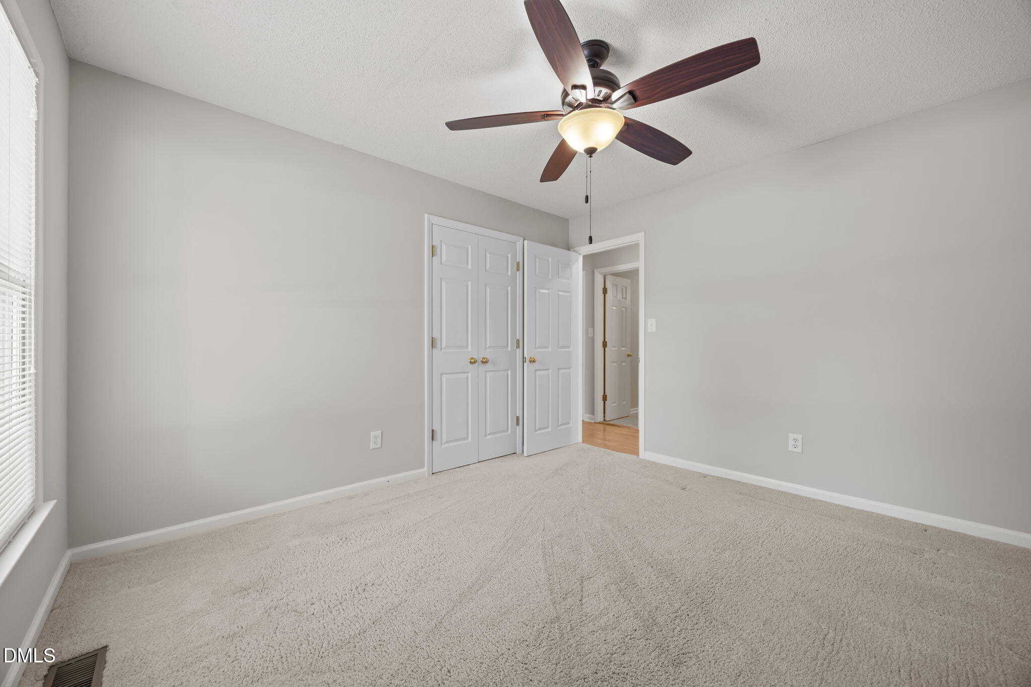 40 Circle Tree Lane Angier, NC 27501 - Photo 27 of 39 an empty room with a window and a fan