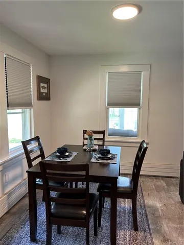 a view of a dining room that has a table and chairs in it