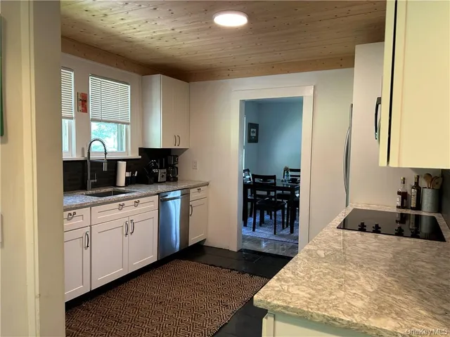 a kitchen with a sink and a refrigerator