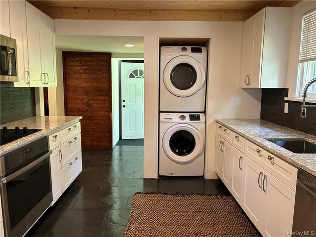 a kitchen with a stove top oven sink and cabinets