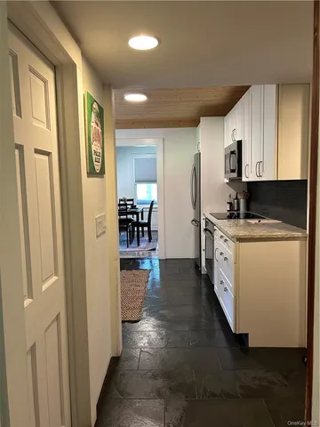 a kitchen with stainless steel appliances a refrigerator sink and cabinets