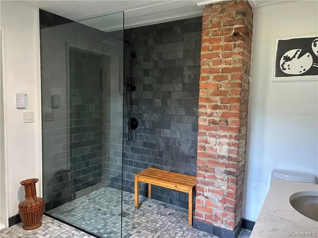 a bathroom with a toilet and a shower