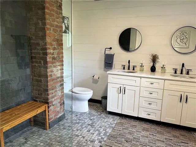 a bathroom with a toilet a sink and mirror