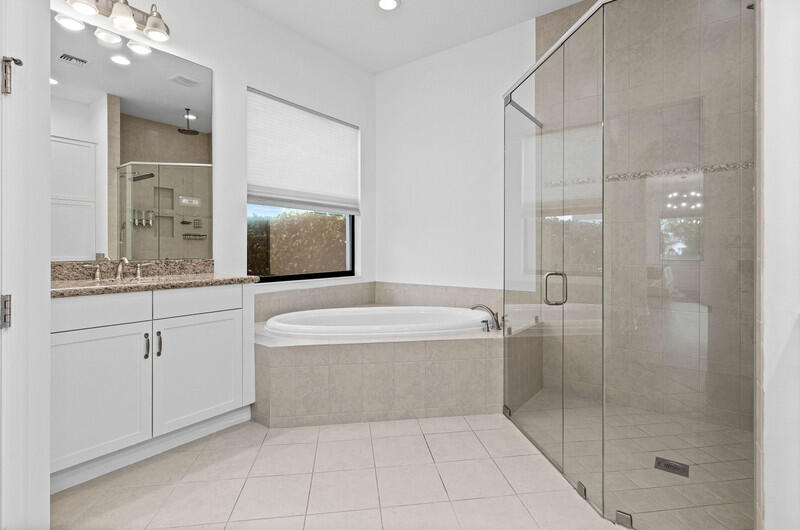 12153 Boca Reserve Lane Boca Raton, FL 33428 - Photo 16 of 35 a spacious bathroom with a shower a mirror and a bathtub