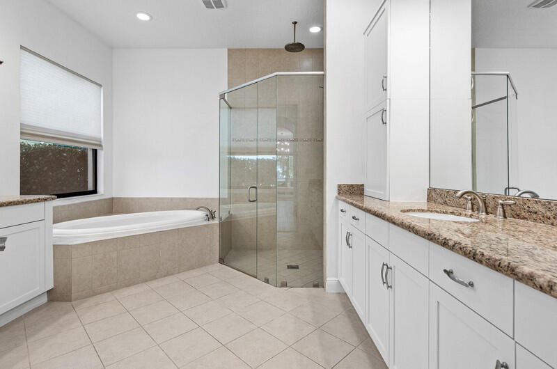 12153 Boca Reserve Lane Boca Raton, FL 33428 - Photo 17 of 35 a bathroom with a granite countertop bathtub shower sink vanity and mirror