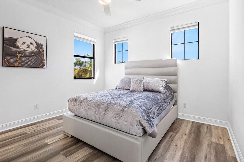 12153 Boca Reserve Lane Boca Raton, FL 33428 - Photo 18 of 35 a bedroom with a bed and a painting on the wall