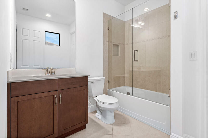12153 Boca Reserve Lane Boca Raton, FL 33428 - Photo 19 of 35 a bathroom with a sink a toilet and shower