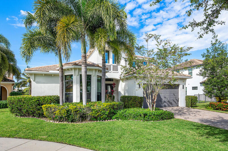 12153 Boca Reserve Lane Boca Raton, FL 33428 - Photo 2 of 35 a front view of a house with a garden