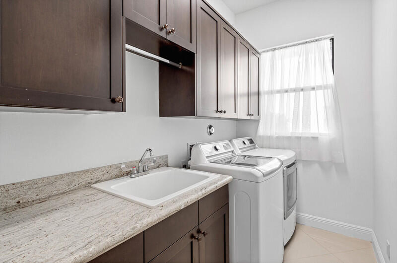 12153 Boca Reserve Lane Boca Raton, FL 33428 - Photo 25 of 35 a bathroom with a sink and a washing machine