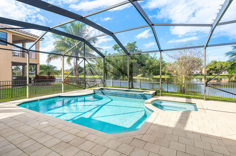 12153 Boca Reserve Lane Boca Raton, FL 33428 - Photo 28 of 35 a view of a swimming pool with a backyard