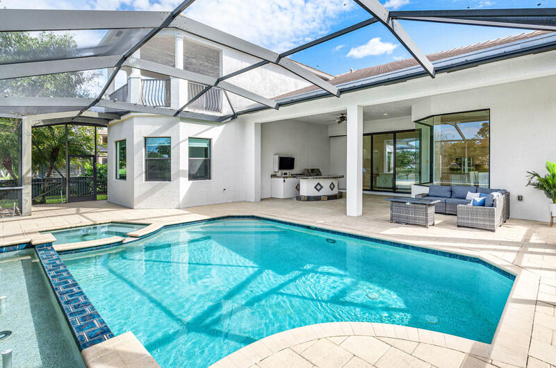 12153 Boca Reserve Lane Boca Raton, FL 33428 - Photo 29 of 35 a swimming pool with outdoor seating and yard