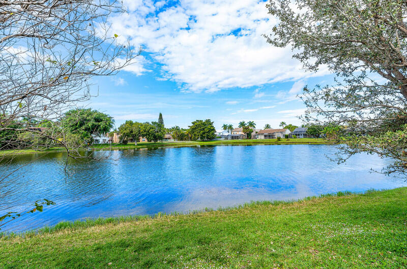 12153 Boca Reserve Lane Boca Raton, FL 33428 - Photo 30 of 35 a view of a lake with houses in the back