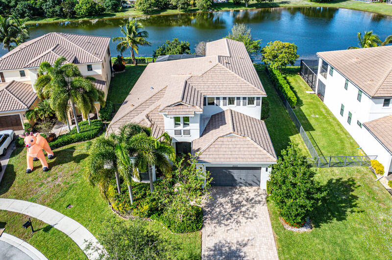 12153 Boca Reserve Lane Boca Raton, FL 33428 - Photo 31 of 35 an aerial view of a house with a garden and lake view