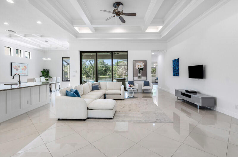 12153 Boca Reserve Lane Boca Raton, FL 33428 - Photo 8 of 35 a living room with furniture and a flat screen tv