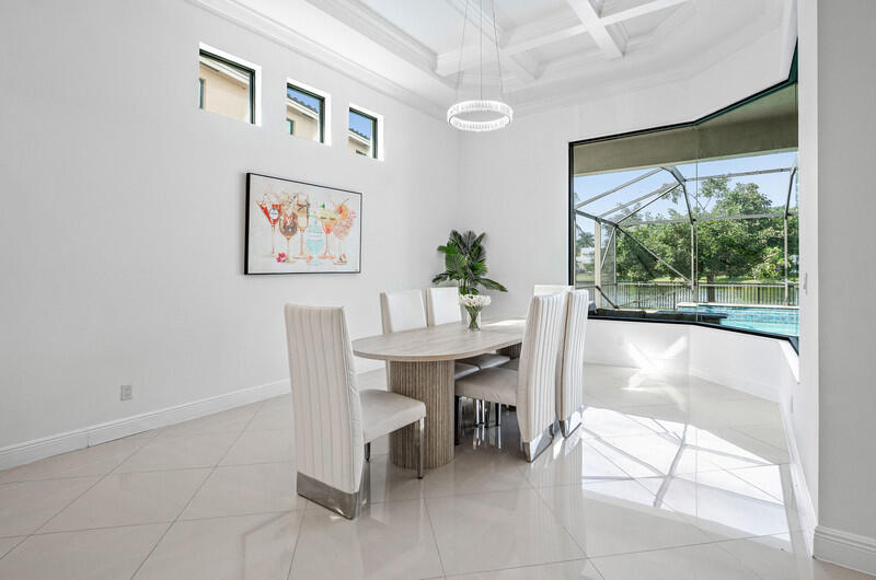 12153 Boca Reserve Lane Boca Raton, FL 33428 - Photo 10 of 35 a view of a dining room with furniture and a large window