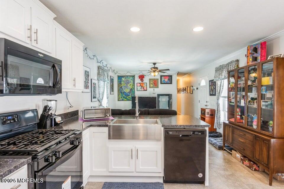 52 Monique Circle Hazlet, NJ 07730 - Photo 4 of 7 a kitchen with stainless steel appliances granite countertop a stove top oven a sink dishwasher and a microwave with wooden floor