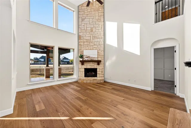 a view of a livingroom with wooden floor and a fireplace