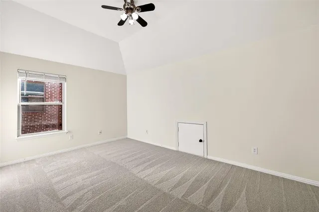a view of an empty room with a fan