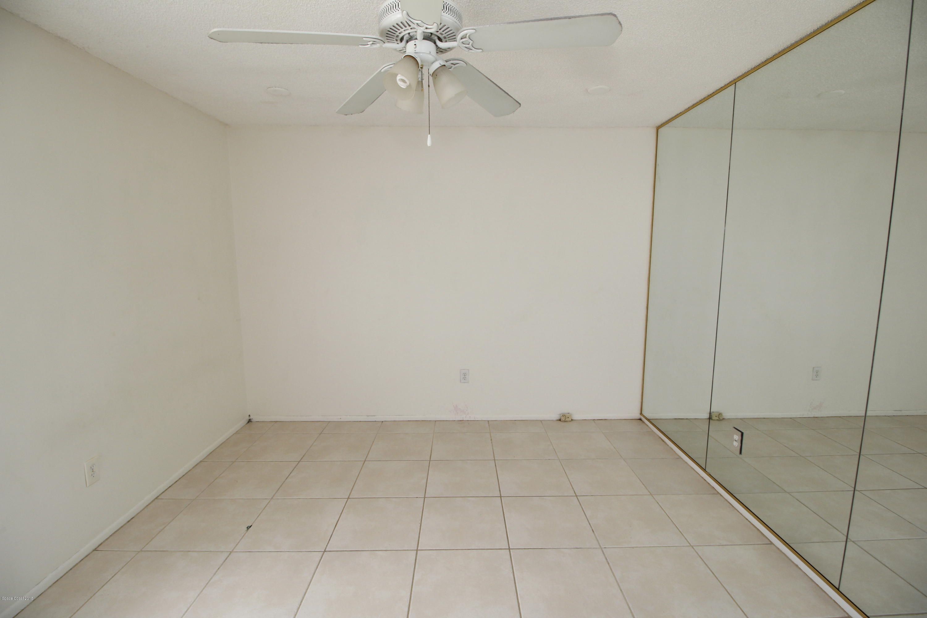 1302 Cherry Hills Road Northeast Palm Bay, FL 32905 - Photo 14 of 24 wooden floor in an empty room