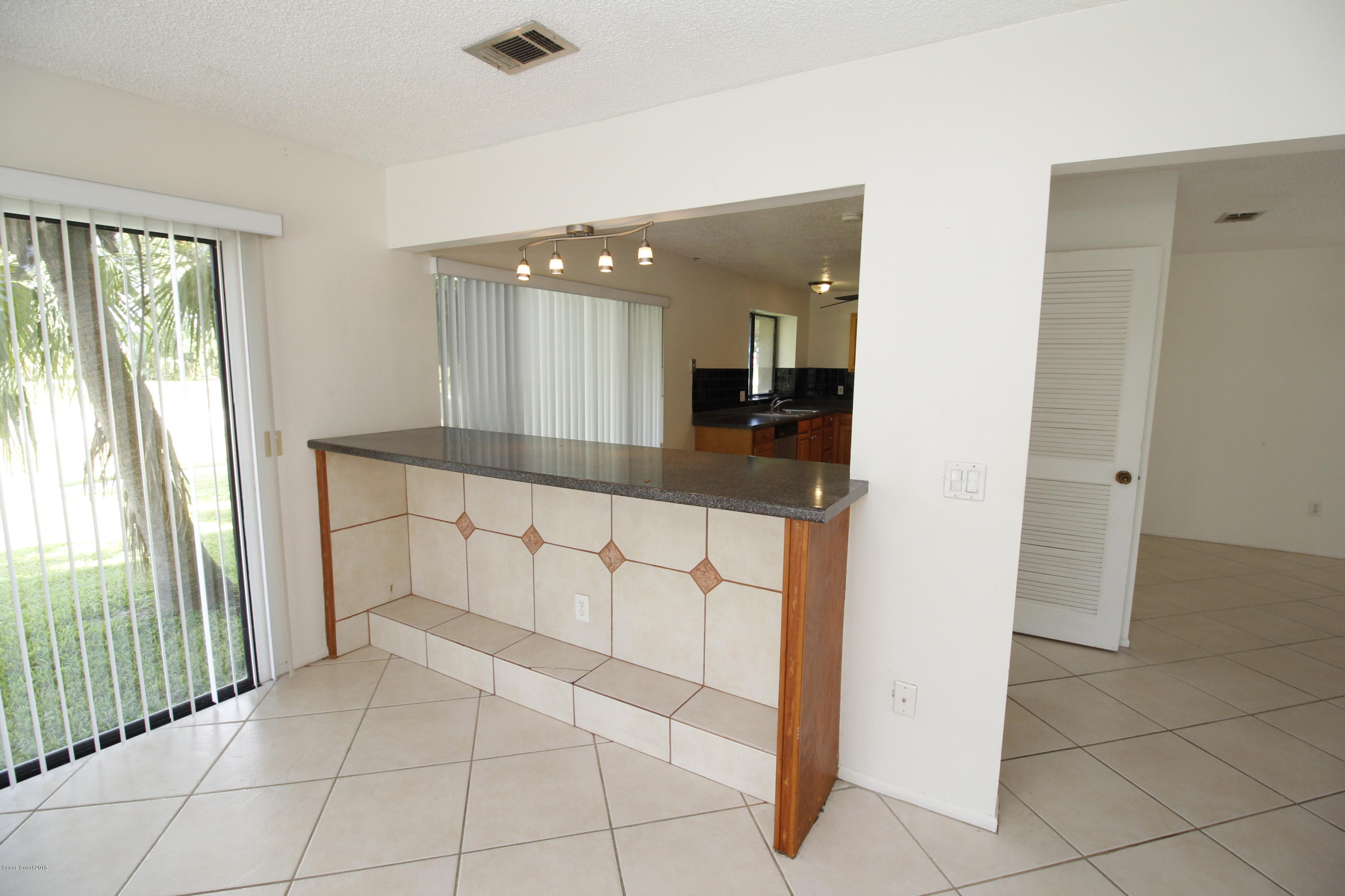 1302 Cherry Hills Road Northeast Palm Bay, FL 32905 - Photo 21 of 24 a spacious bathroom with a glass door shower and a sink