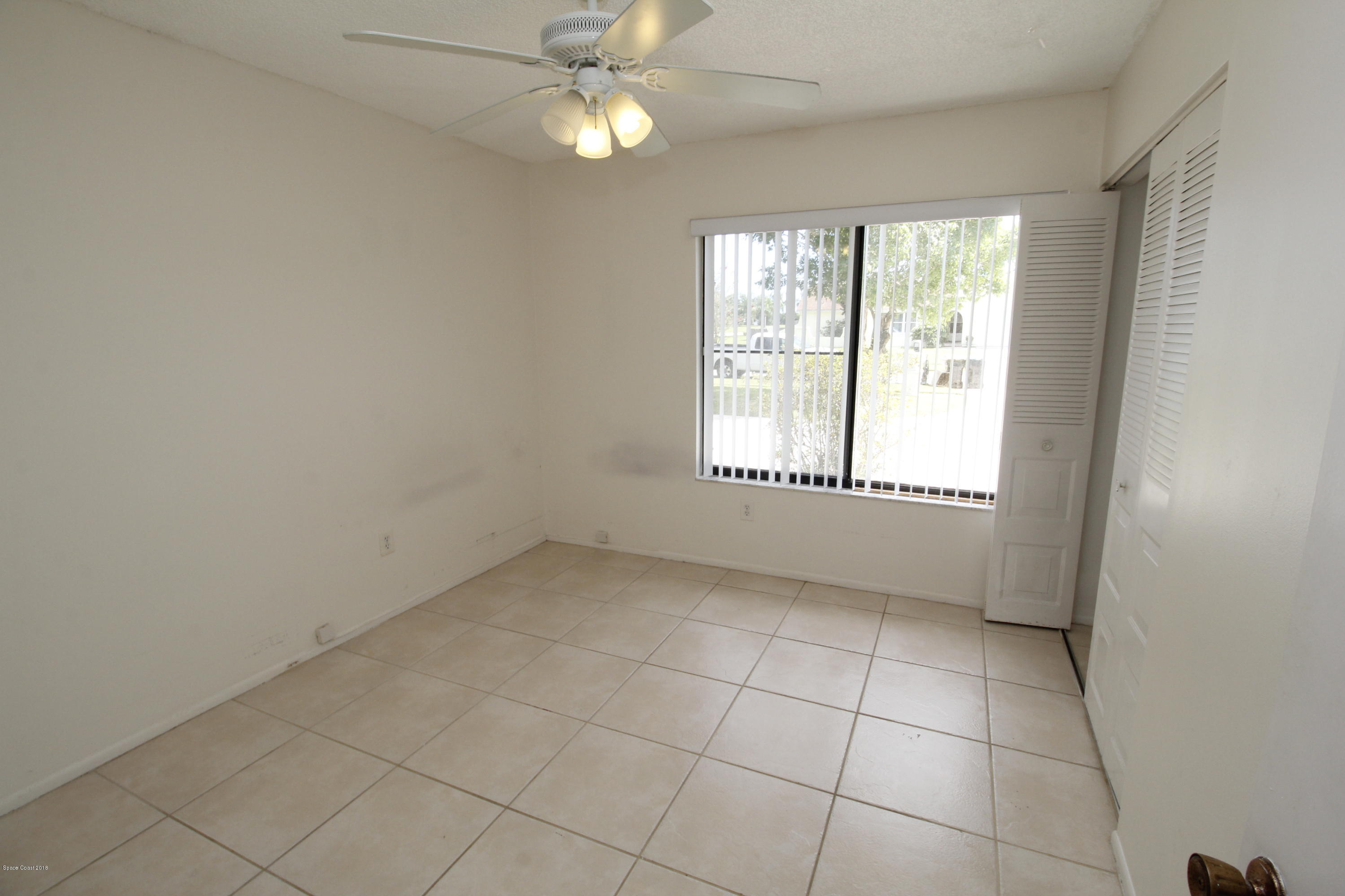 1302 Cherry Hills Road Northeast Palm Bay, FL 32905 - Photo 22 of 24 an empty room with a empty space and a window