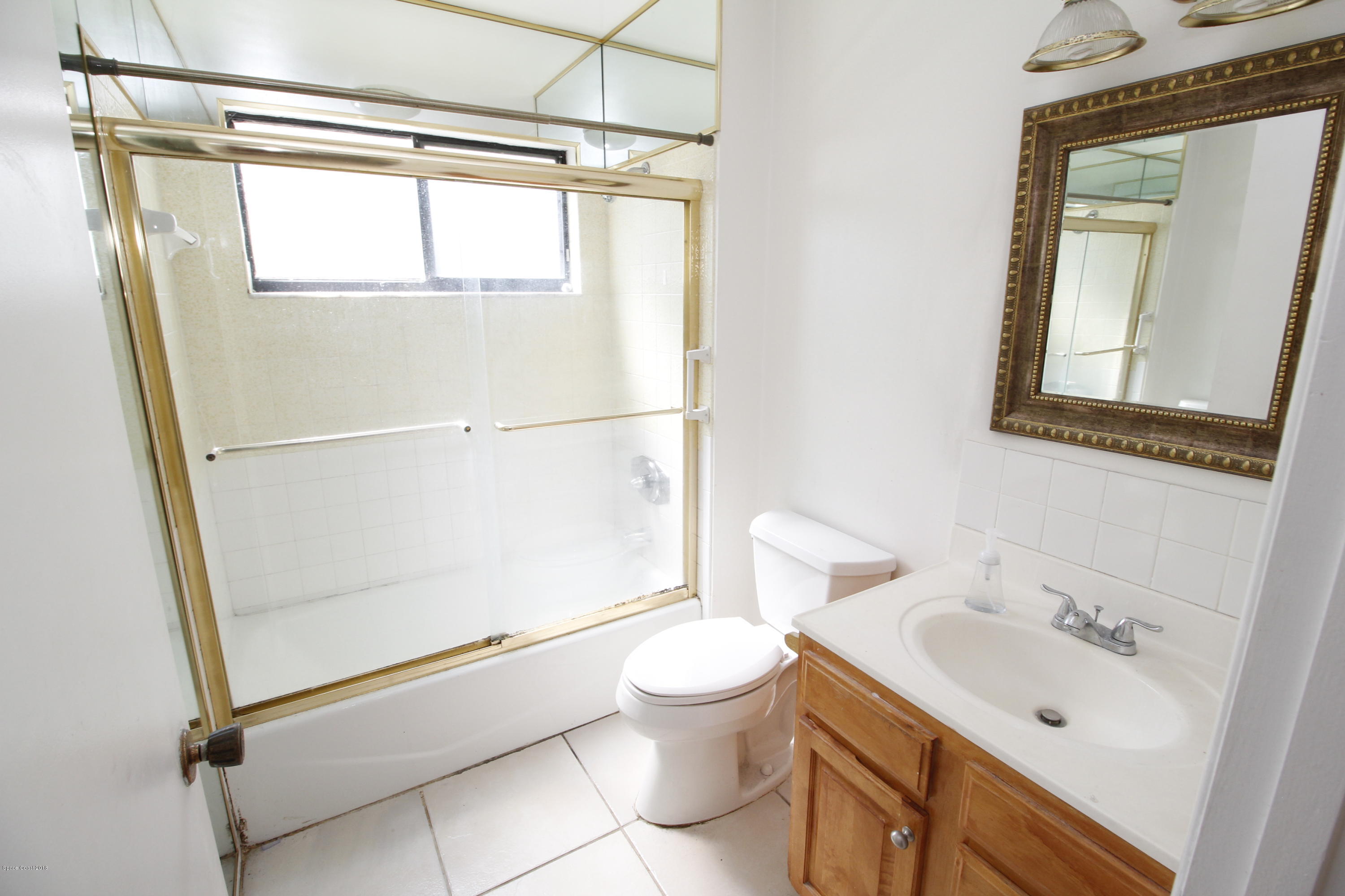 1302 Cherry Hills Road Northeast Palm Bay, FL 32905 - Photo 23 of 24 a bathroom with a granite countertop sink toilet and shower