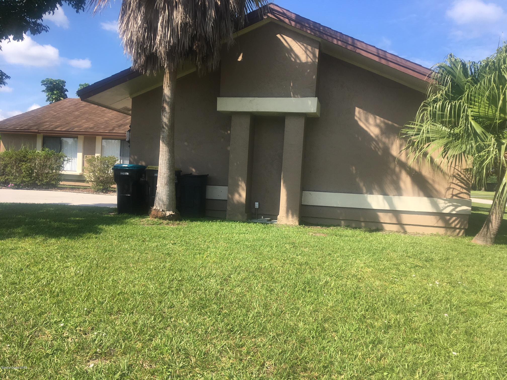 1302 Cherry Hills Road Northeast Palm Bay, FL 32905 - Photo 5 of 24 a front view of a house with a yard