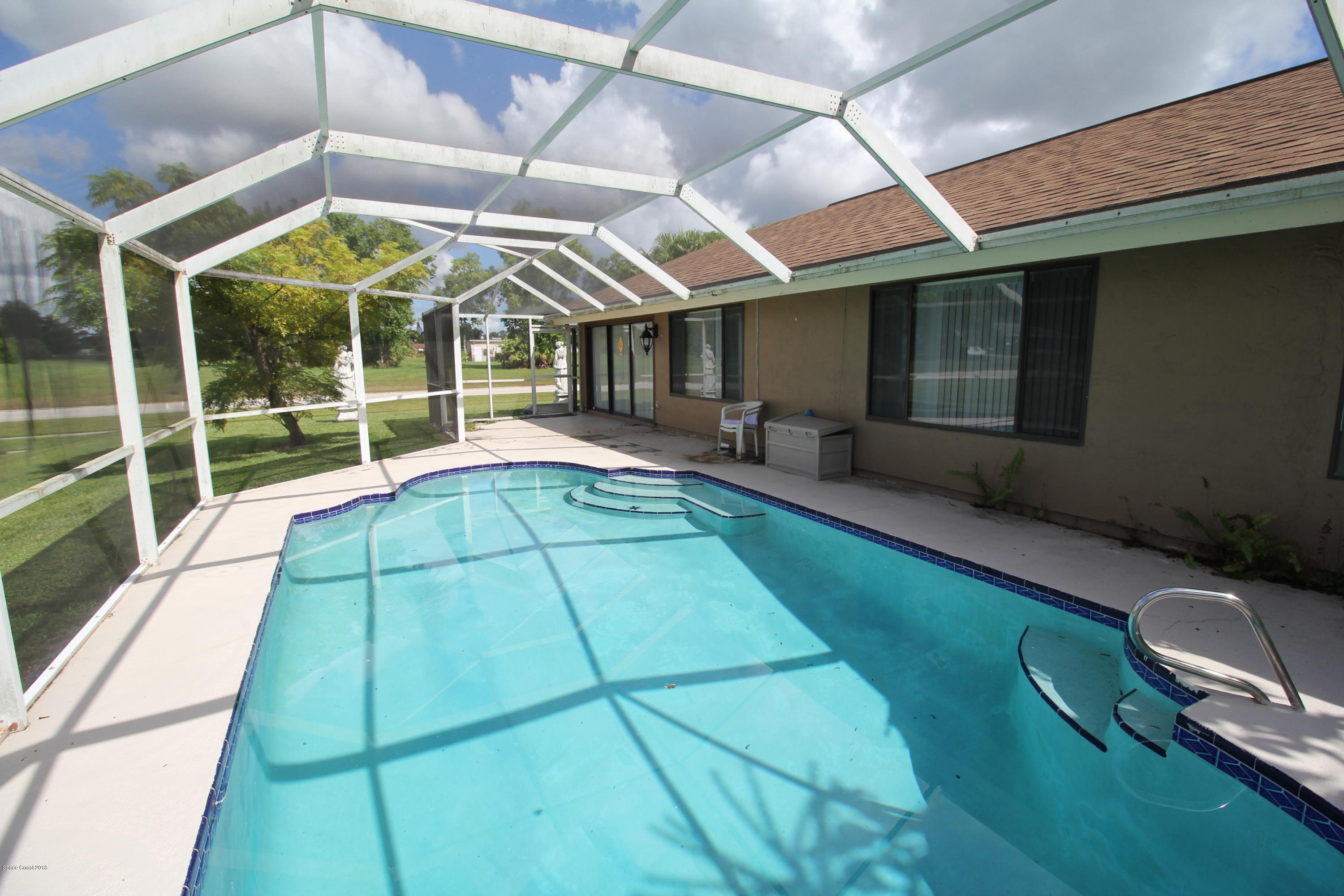 1302 Cherry Hills Road Northeast Palm Bay, FL 32905 - Photo 10 of 24 a view of a backyard with a patio