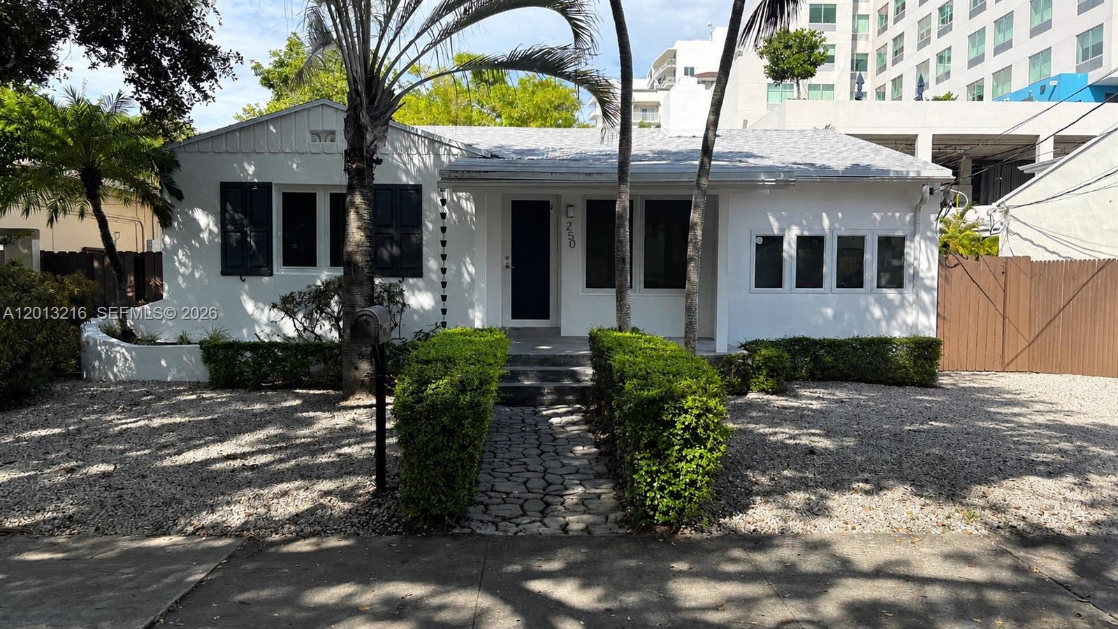 a front view of house with a garden