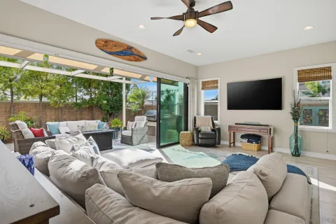 a living room with furniture a fireplace and a flat screen tv