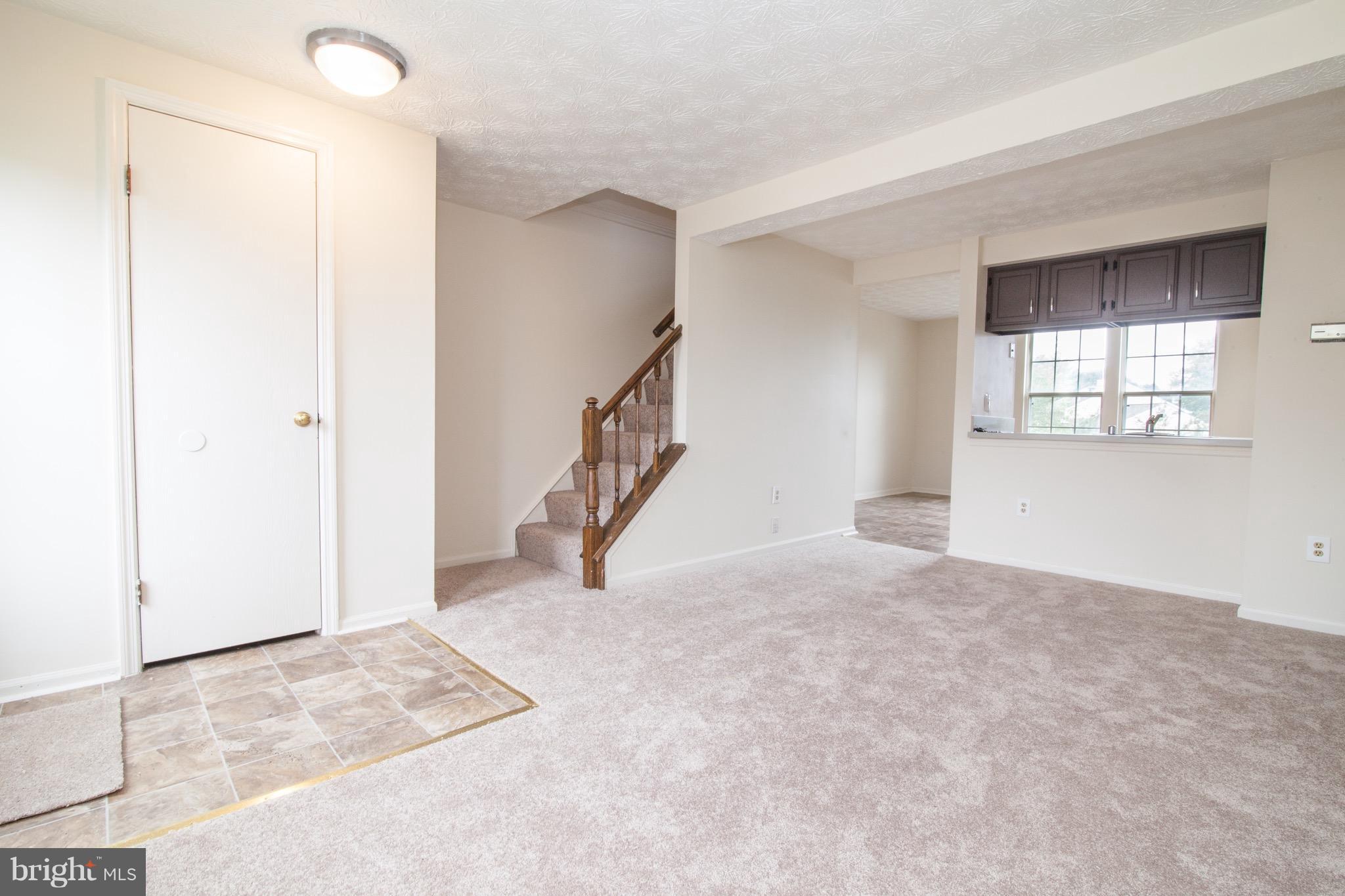 1319 Apple Ridge Court Edgewood, MD 21040 - Photo 8 of 23 an empty room with windows and stairs