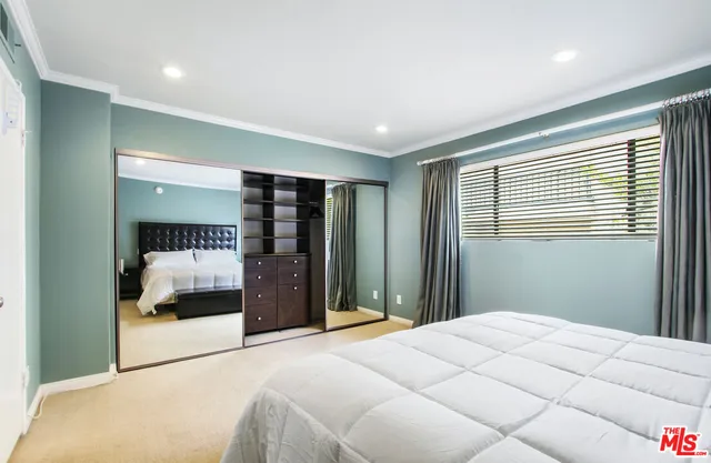 a bedroom with a large bed and a large window