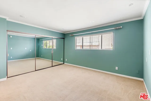 a view of an empty room with glass door