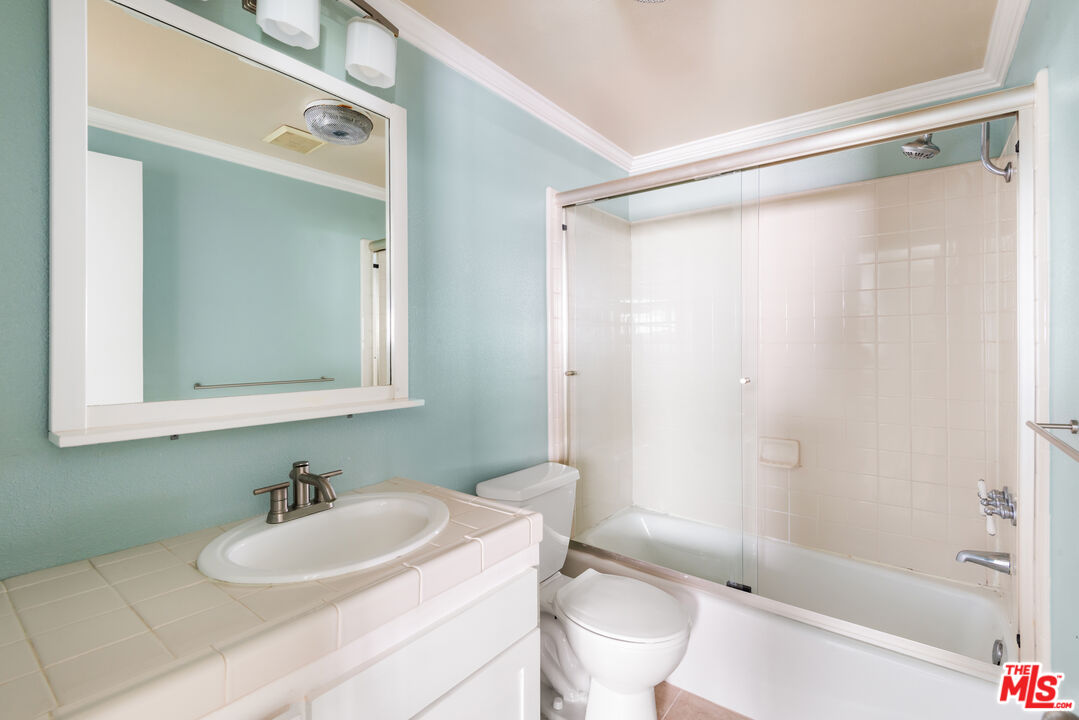 10671 Wilkins Avenue, Unit 5 Los Angeles, CA 90024 - Photo 18 of 28 a bathroom with a sink mirror toilet and shower