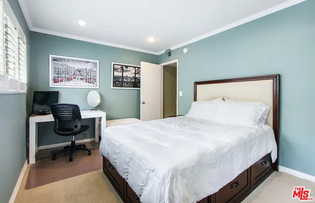 a bedroom with a bed a desk and chair