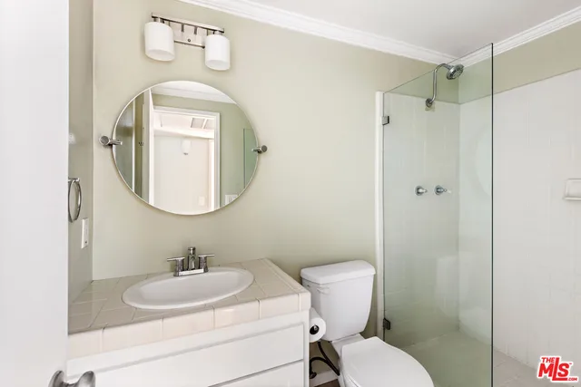 a bathroom with a toilet a sink and a mirror