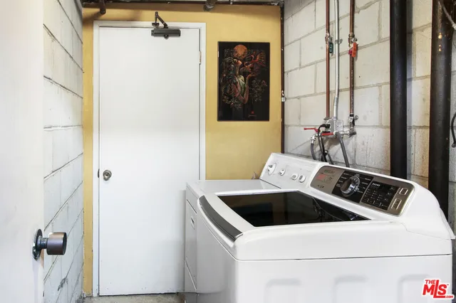 a bathroom with a sink and washing machine