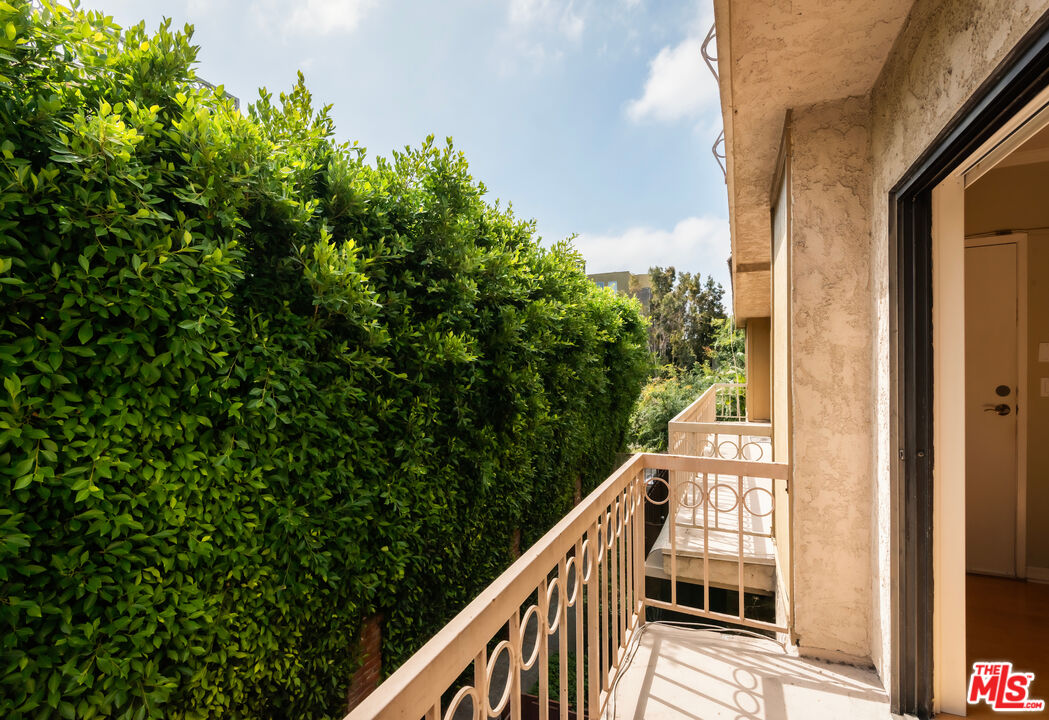 10671 Wilkins Avenue, Unit 5 Los Angeles, CA 90024 - Photo 8 of 28 a balcony with wooden floor and yard in the back