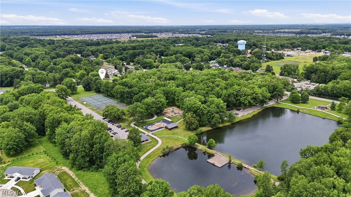 7474 Avon Belden Road North Ridgeville, OH 44039 - Photo 6 of 6 Expansive green spaces featuring mature trees, two distinct ponds with a wooden pier, and paved walking paths