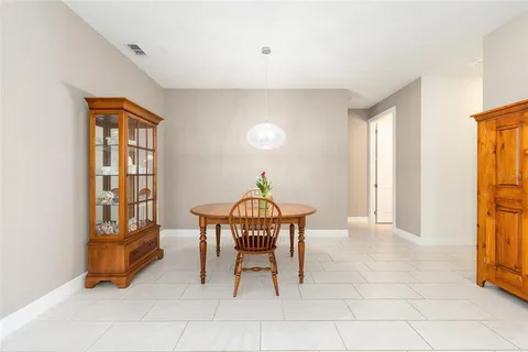 a dining room with furniture and a window