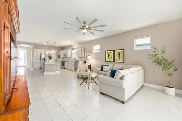 a living room with furniture and a potted plant
