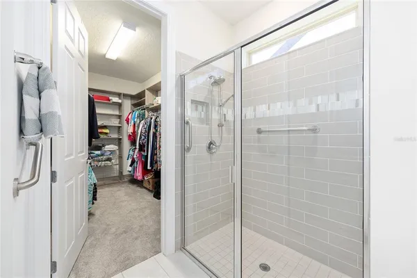 a view of a walk in closet and bathroom