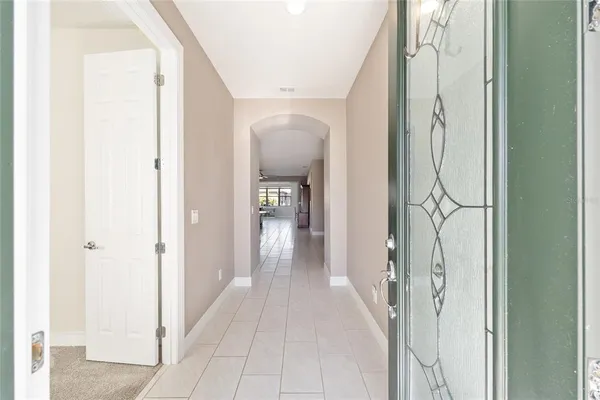a view of a hallway with wooden floor and glass door