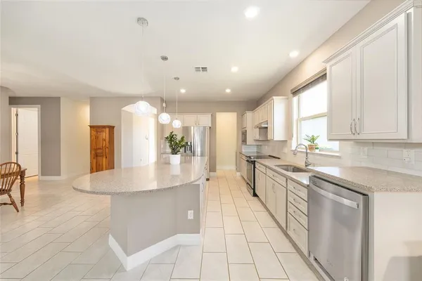 a large white kitchen with a large window