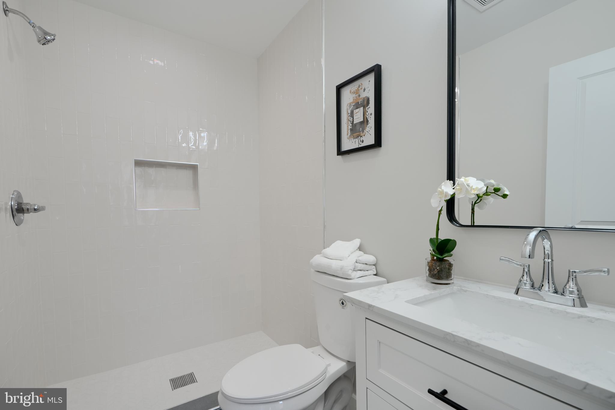 602 South Streeper Street Baltimore, MD 21224 - Photo 14 of 31 a bathroom with a sink a toilet and mirror
