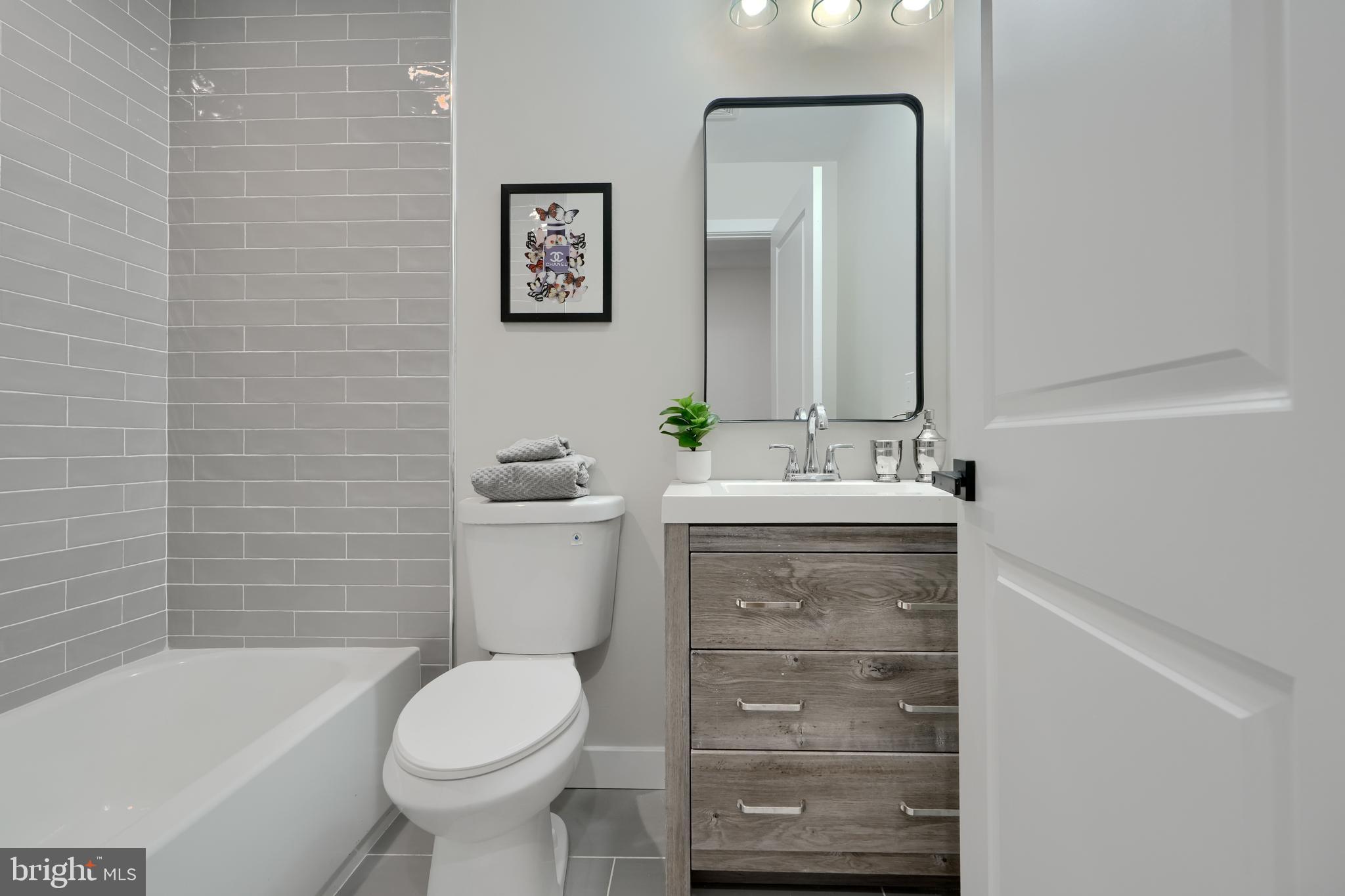 602 South Streeper Street Baltimore, MD 21224 - Photo 16 of 31 a bathroom with a sink toilet and shower